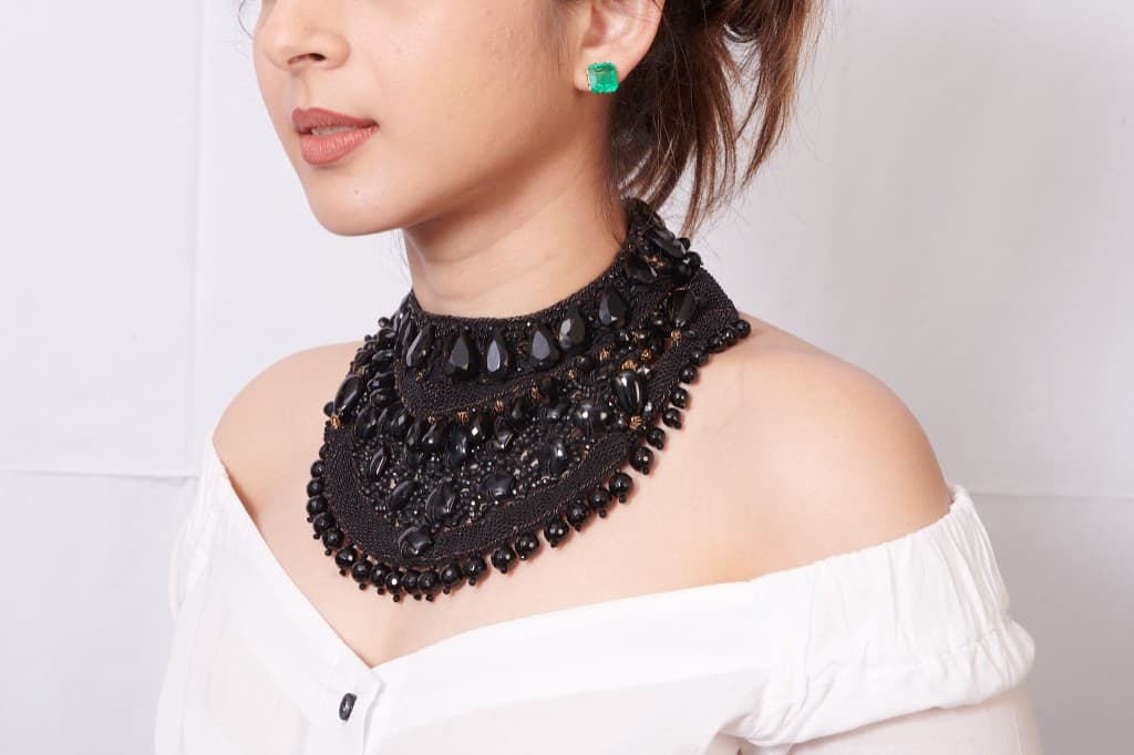 Model wearing black beaded choker